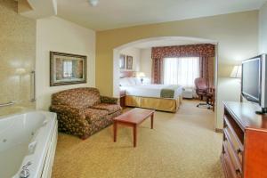 a hotel room with a bed and a bathroom at Holiday Inn Express Hotel & Suites Las Cruces, an IHG Hotel in Las Cruces
