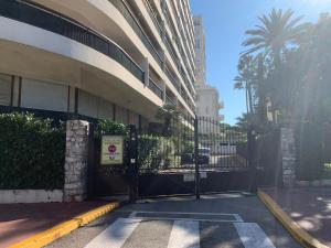 una puerta frente a un edificio con una palmera en Gallia Bella By SCLS Locations, en Cannes