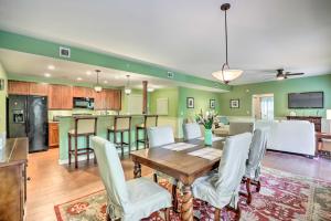 a dining room and kitchen with a table and chairs at World Golf Village Resort Escape with Pool Access! in St. Augustine