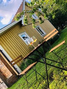 a house with a deck on the side of it at Obstgarten Mörlunda, 5 min zum Badesee, Småland, Sauna in Mörlunda