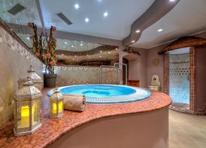 a large bathroom with a jacuzzi tub at Hotel Pejo in Peio Fonti