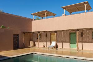 a house with a swimming pool and a patio at Côté Sud in Ouarzazate