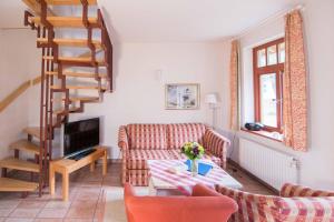 a living room with a couch and a table at Ferienhaussiedlung Strandperlen Buchenhof 3a (Typ III) in Wustrow