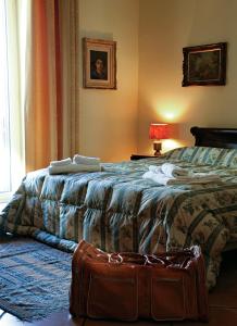 una camera con un letto e una valigia sul pavimento di B&B Luna Caprese a Napoli Altre 20 foto