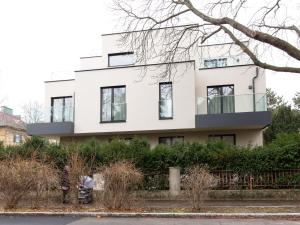 a white house with black windows at Premium Green Apartments Vienna in Vienna