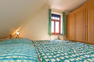 Postel nebo postele na pokoji v ubytování Ferienhaussiedlung Strandperlen Sanddornhof 2c (Typ II)