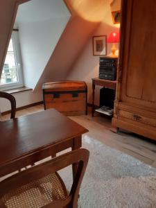 a living room with a wooden table and a desk at Chambres d'hôtes ''La Grand' Maison'' in Escalles