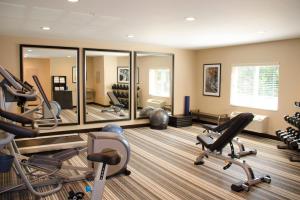 a gym with several exercise bikes and mirrors at Candlewood Suites - Lancaster West, an IHG Hotel in Lancaster