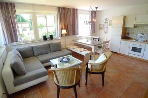 a living room with a couch and a table at BIRKENHOF Whg. BH-41 in Wustrow