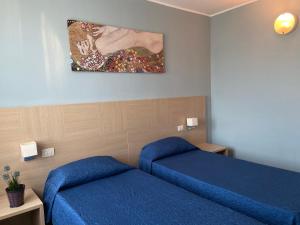 Postel nebo postele na pokoji v ubytování Hotel Santa Giulia