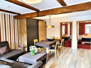 a living room and dining room with a table and chairs at Apart Hotel Wernigerode in Wernigerode
