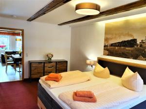 a bedroom with two beds and a painting on the wall at Apart Hotel Wernigerode in Wernigerode