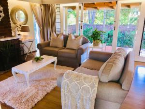 a living room with two couches and a table at Retreat in Hillcrest