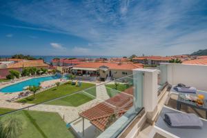 an aerial view of a house with a swimming pool and a yard at Hotel Palmyra in Argassi