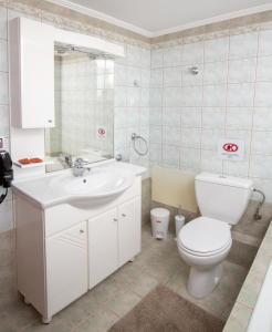a bathroom with a white toilet and a sink at Angel-kolymvari4you in Kolymvari +24 photos