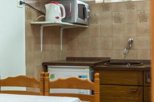 a kitchen with a microwave and a counter top at Villa Roko in Tučepi