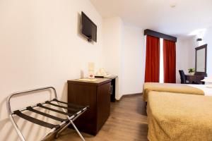 a hotel room with two beds and a tv at Hotel Duke Armeneasca - Ex Tempo in Bucharest