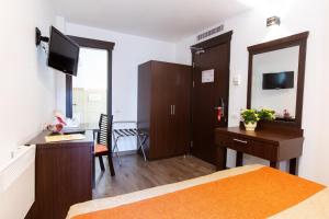 a bedroom with a bed and a desk and a desk at Hotel Duke Armeneasca - Ex Tempo in Bucharest