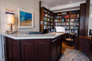 a library with a large island in a room with books at Port Charlotte Hotel in Port Charlotte