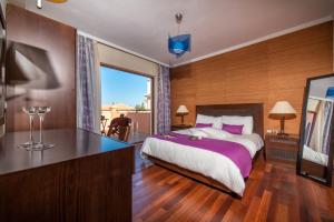 a bedroom with a large bed and a large window at Hotel St John Villas in Tsilivi