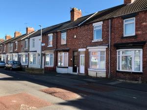 Une rangée de maisons en briques dans une rue dans l'établissement Jodon House, à Middlesbrough