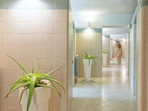 a bathroom with two potted plants in a hallway at Hotel San Giorgio Terme in Ischia