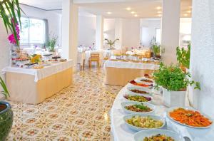 a buffet line with plates of food and tables at Hotel San Giorgio Terme in Ischia