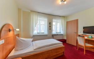 Postel nebo postele na pokoji v ubytování Hotel Kirchhainer Hof