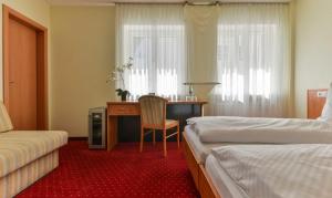 Postel nebo postele na pokoji v ubytování Hotel Kirchhainer Hof