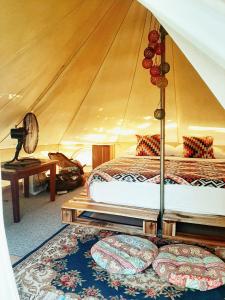 a bedroom with two beds in a tent at Cabanas de Nacpan Camping Resort in El Nido