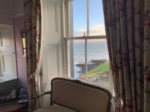 a room with a window with a view of the ocean at Port Charlotte Hotel in Port Charlotte