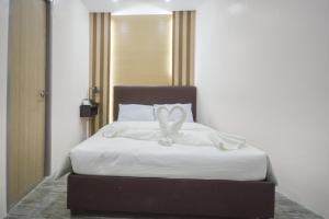 Voodi või voodid majutusasutuse Emerald Island Hotel toas