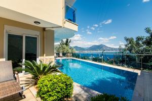 a swimming pool in a house with a view of the water at Alanya Castle Apartment - Adult Only in Alanya