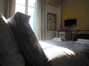 a bedroom with a large bed with a window at Blue Dolphin in Batsi