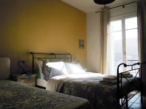 a bedroom with two beds and a window at Blue Dolphin in Batsi