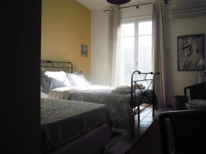 a bedroom with two beds and a window at Blue Dolphin in Batsi