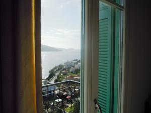 a view of the ocean from a window at Blue Dolphin in Batsi