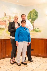 a group of people posing for a picture in a room at Hotel Kirchhainer Hof in Kirchhain