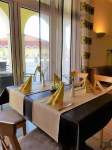 a dining room table with chairs and umbrellas at Warias Hotel & Restaurant in Braunsbedra