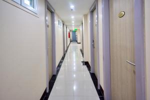 a corridor of a hospital hallway with white floors and doors at Emerald Island Hotel in Boracay