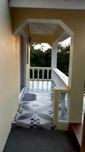 a balcony with a tiled floor in a building at Candy Haven in Morne Jaloux Ridge
