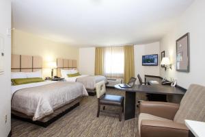 Кровать или кровати в номере Candlewood Suites New Braunfels, an IHG Hotel