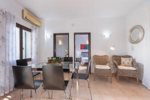 a dining room with a glass table and chairs at Holiday Home Marina 9 in Portals Nous