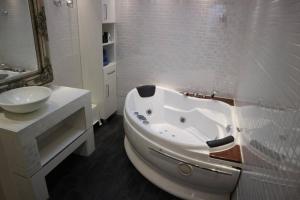 a white bathroom with a tub and a sink at Lake House 74, luxury accommodation ir Sauna in Warmond +63 photos