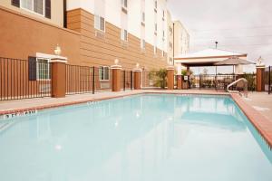 a swimming pool in front of a building at Candlewood Suites San Antonio Downtown, an IHG Hotel in San Antonio