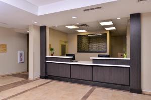 a lobby of a hospital with a waiting room at Candlewood Suites Kenedy, an IHG Hotel in Kenedy