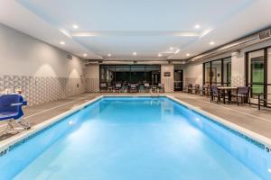 a large swimming pool with blue water in a building at Holiday Inn & Suites Cedar Falls-Waterloo Event Ctr, an IHG Hotel in Cedar Falls