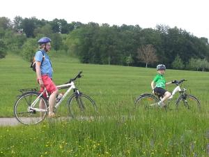 a man and a child riding bikes in a field at Schöne, große Ferienwohnung in Waldenbuch, nahe Stuttgart Messe, Böblingen, Sindelfingen in Waldenbuch