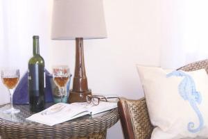 a table with a bottle of wine and glasses on it at Kikas Cottage, Rear 89 Church Street, White Horse Yard in Whitby +7 photos