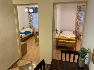 a view of a room with two beds and a mirror at Viktor rooms in Kotor